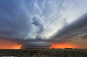 A supercell cloud mushrooms against