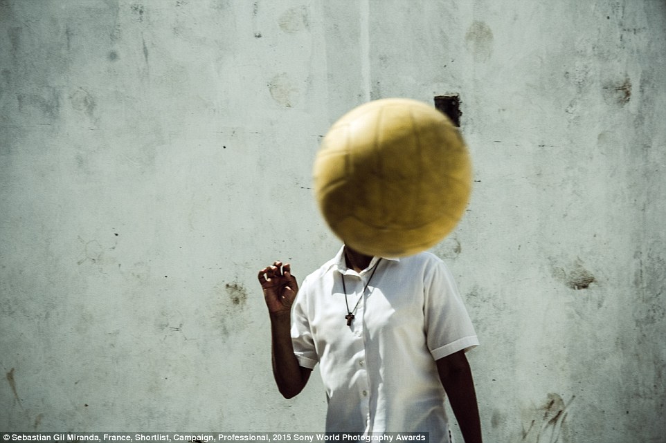 A boy plays football in Villa La Carcova