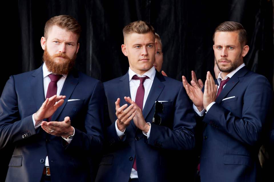 Iceland national football players Gylfi Sigurdsson (R), Alfred Finnbogason (C) and Aron Gunnarsson (L) arrive in Reykjavik on July 4, 2016 after losing against France during the the Euro 2016 quarter-final football match between France and Iceland on the day before. / AFP PHOTO / Karl PeterssonKARL PETERSSON/AFP/Getty Images